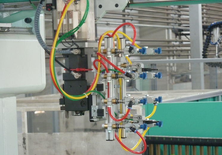 A Gripper with Thermalon Vacuum Cups for Rapid Demolding of Injection Molded Parts from an 8 Cavity Mold